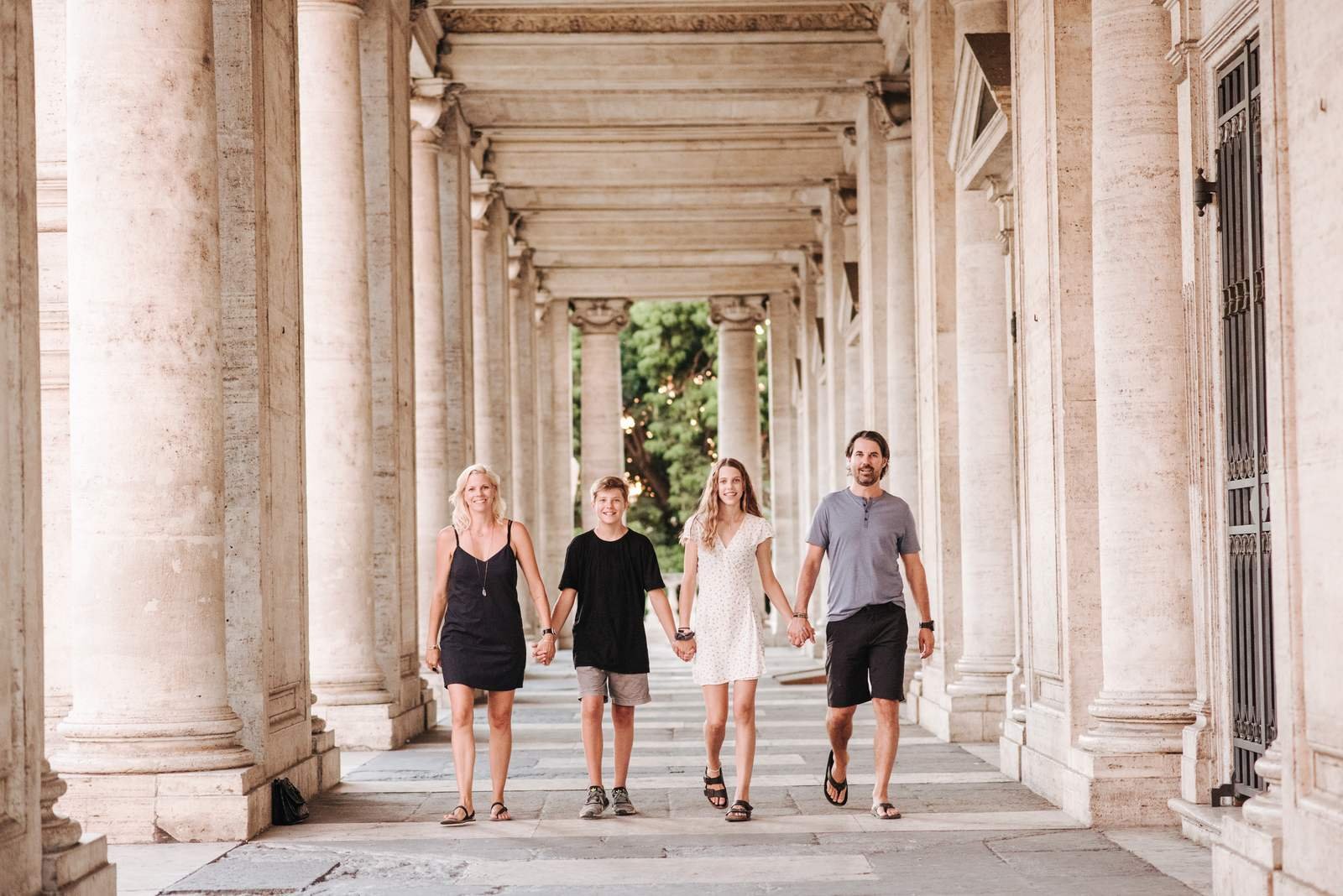 A family walking under the Capitoline colonnade