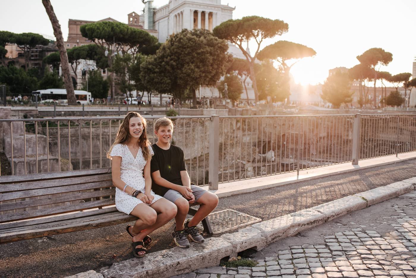A family on a bench above the Forum at sunset