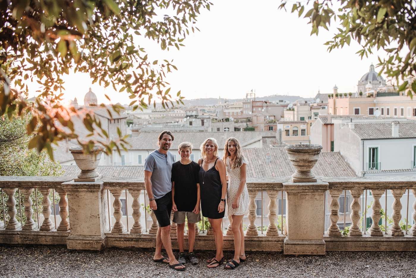 A family at the balustrade with the city behind