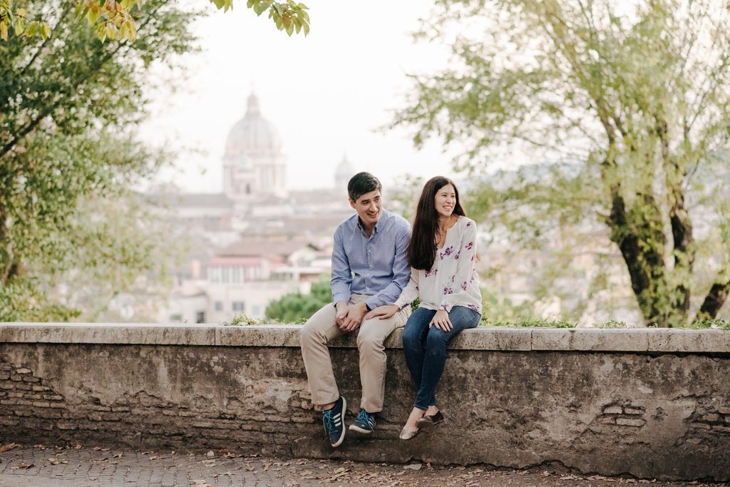 A family sitting on the wall above Rome