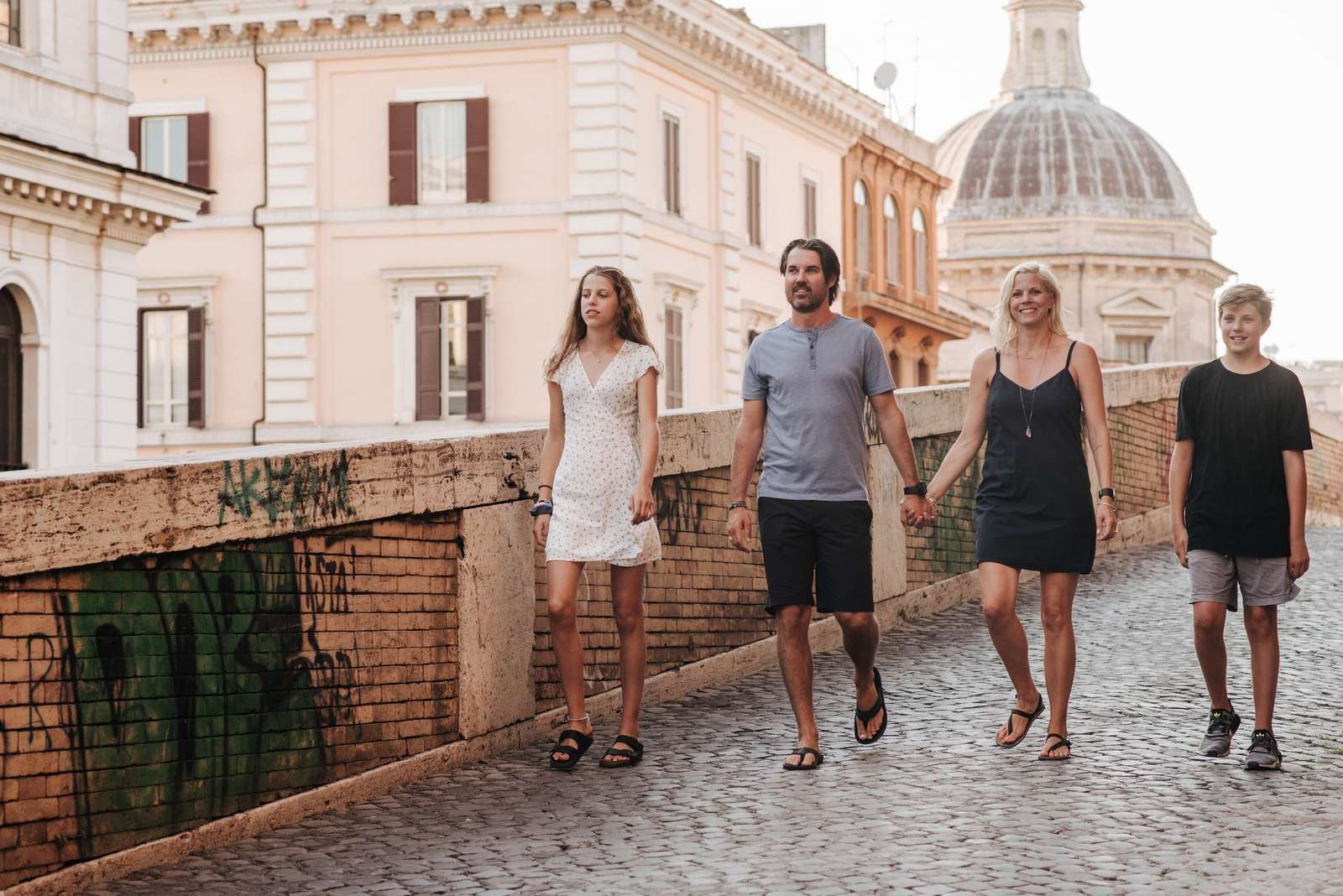 A family walking along a Roman street