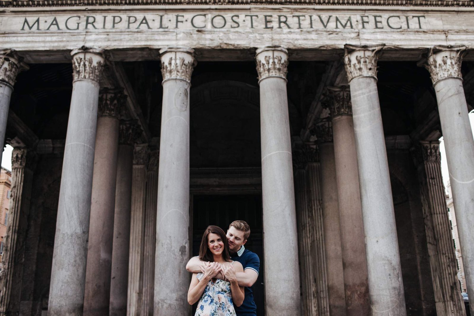 A couple embracing under the Pantheon portico