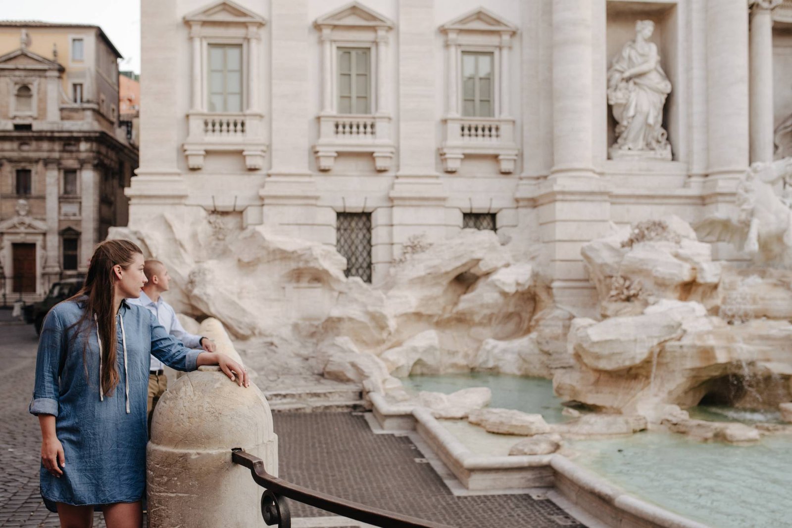 A woman looking back at the Trevi Fountain