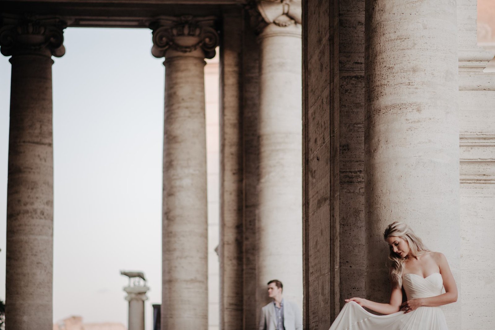 A bride among the columns at sunset