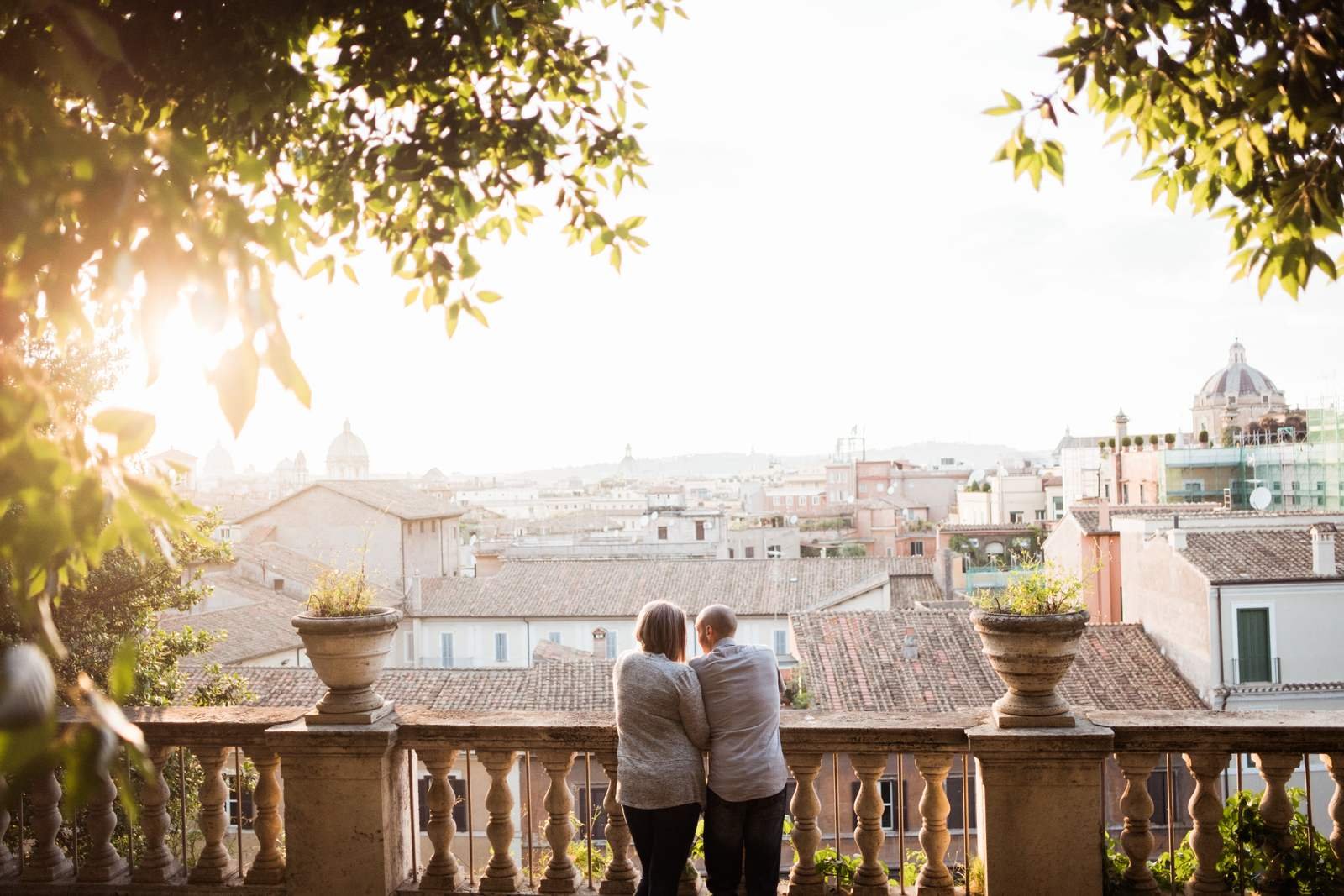 A couple on a terrace above Rome at sunset