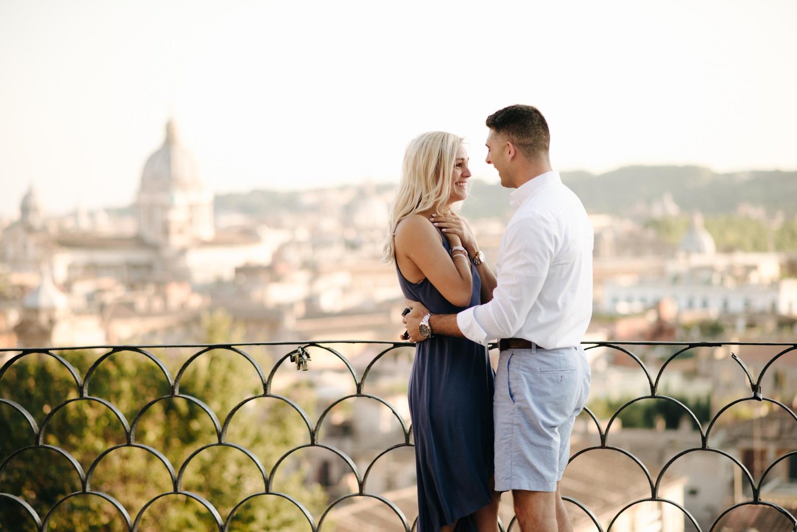 A couple embracing on the terrace after the proposal