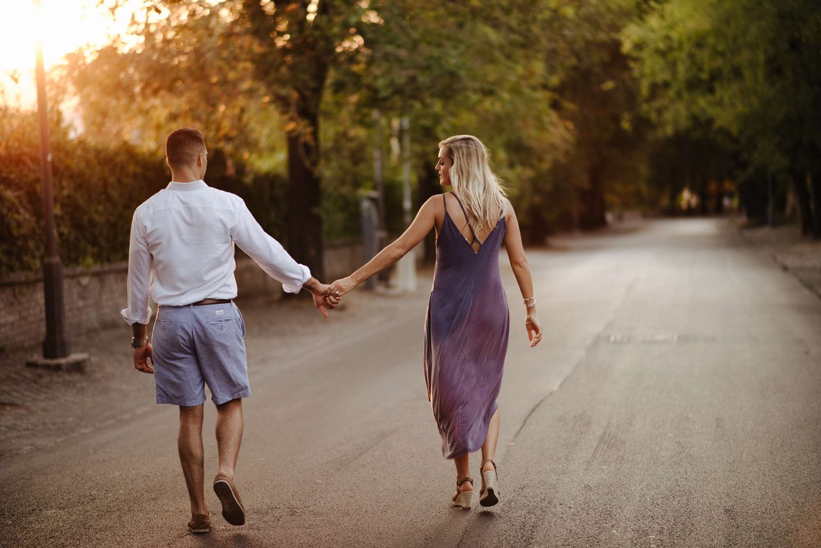 A couple walking hand in hand through the gardens