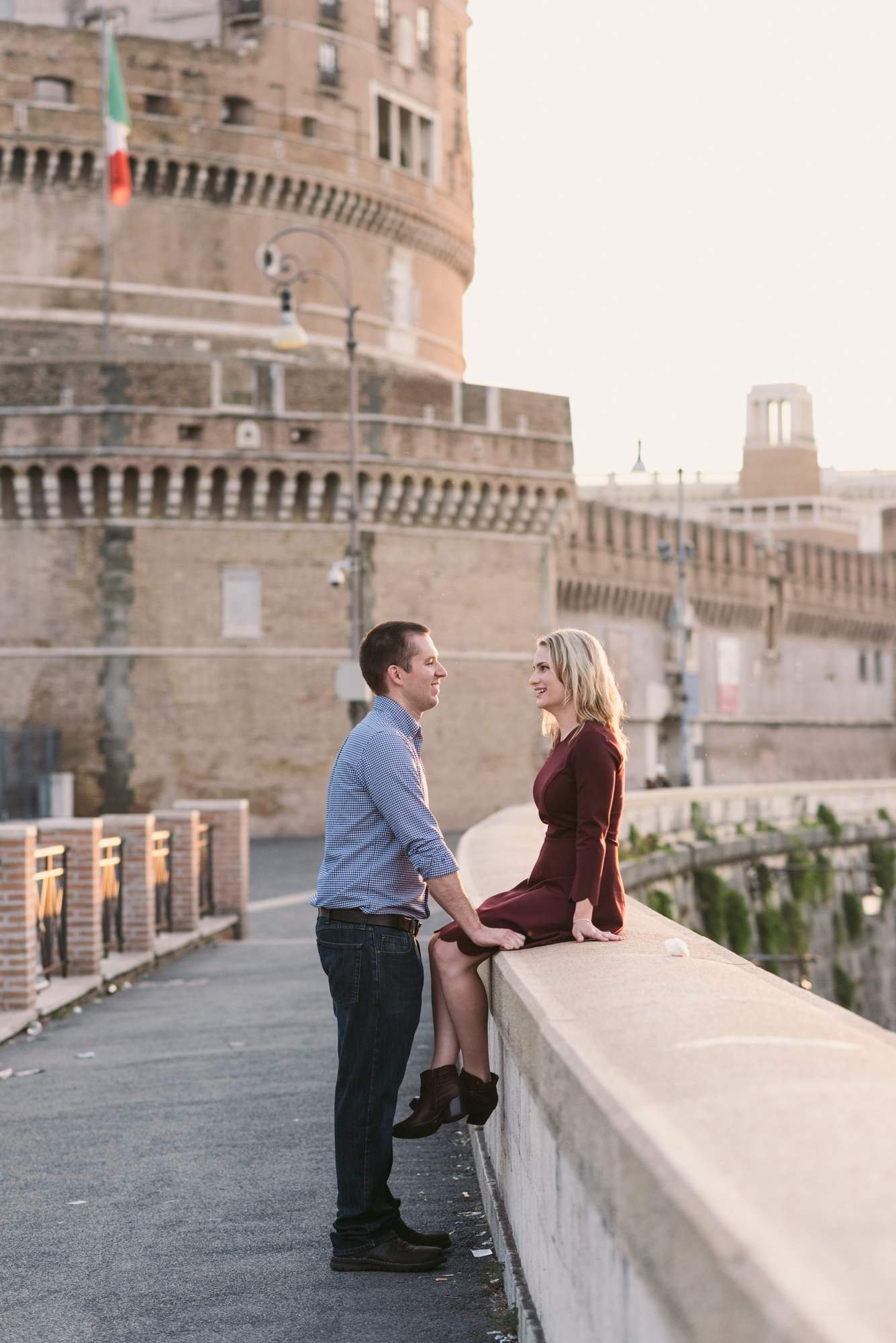 A couple on Ponte Sant'Angelo with the castle behind