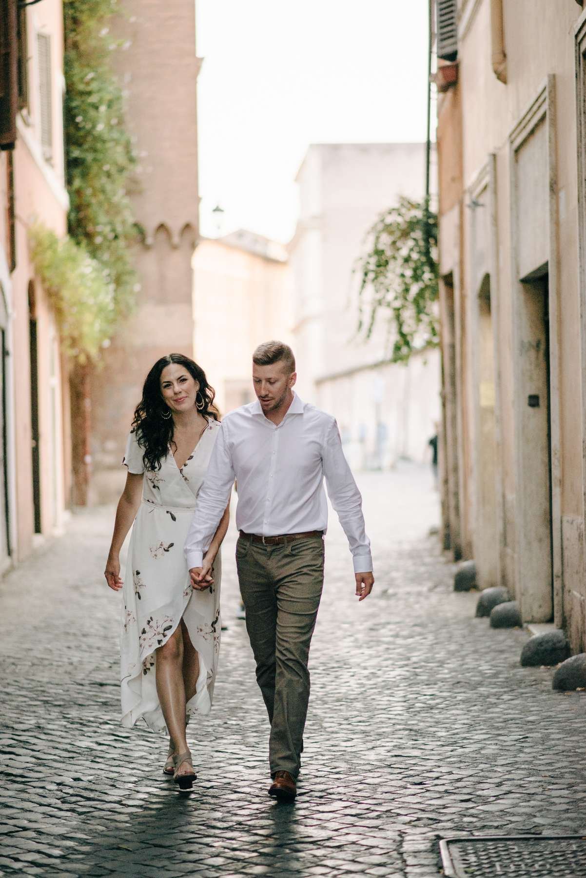 A couple walking hand in hand down an alley in Trastevere