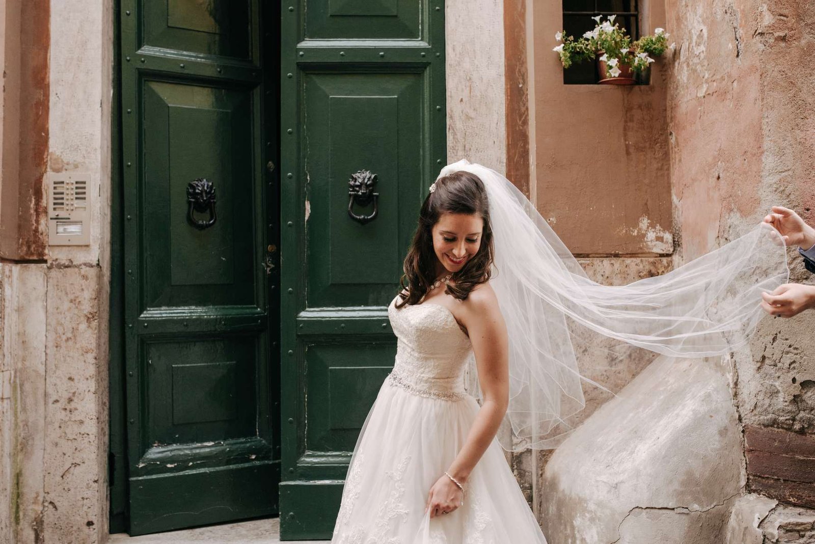 A bride turning in front of a green door