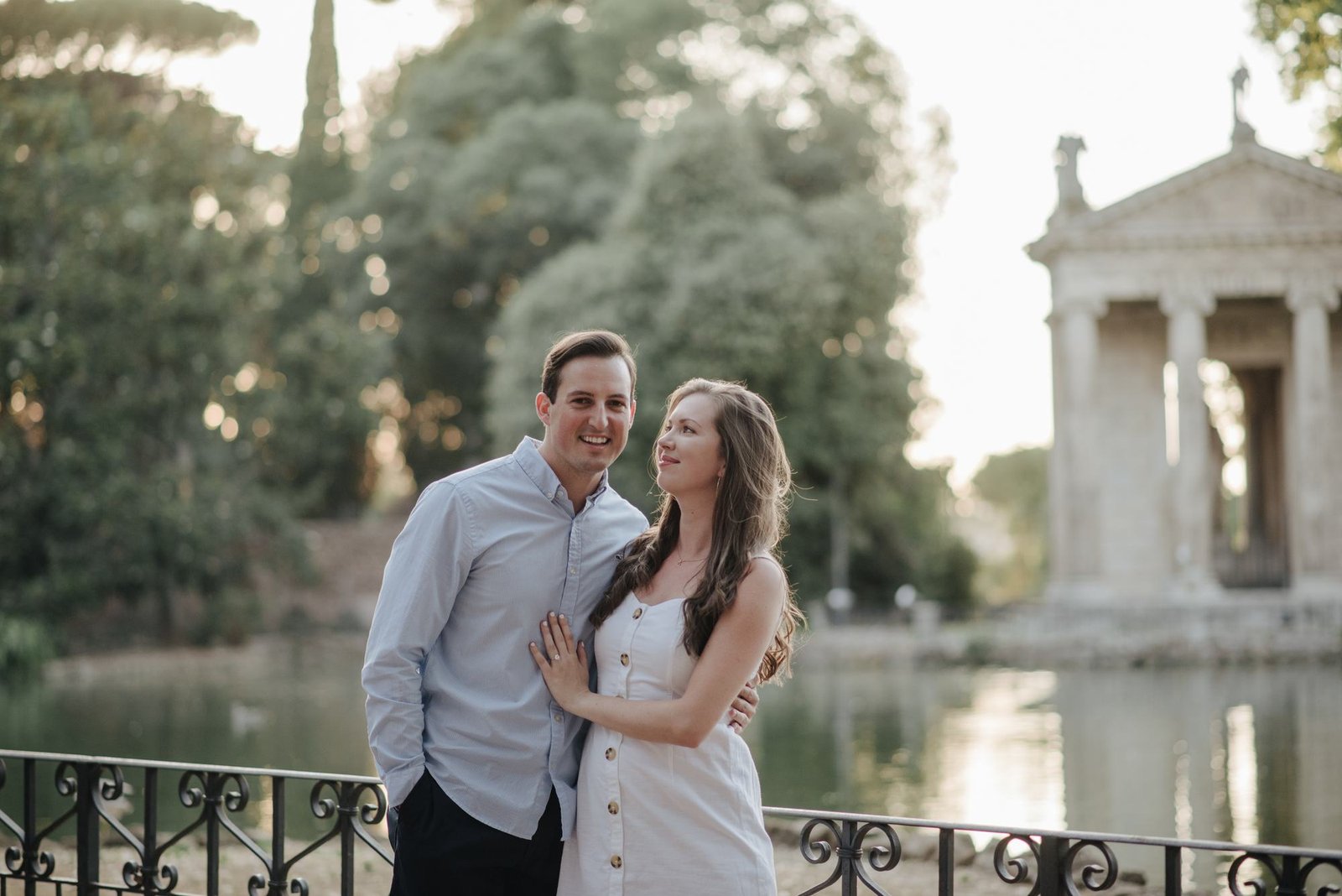 A couple by the temple on the lake in Villa Borghese